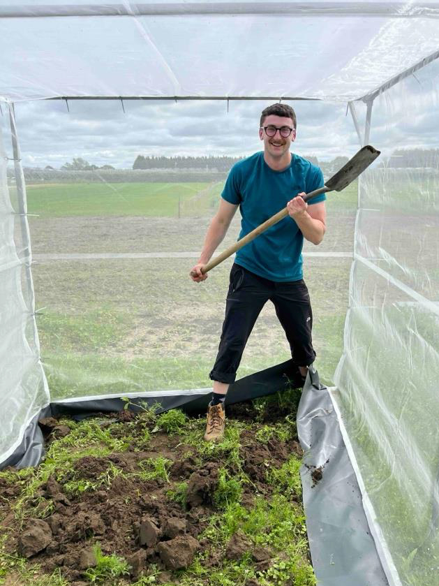 Jamie with a spade digging the bee nests out.